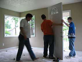 Moving new door into place