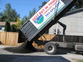 Compost being unloaded on the driveway