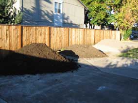 Compost, topsoil, pea gravel, and mason's sand on driveway