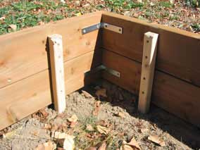 Stakes at corner of planting bed wall