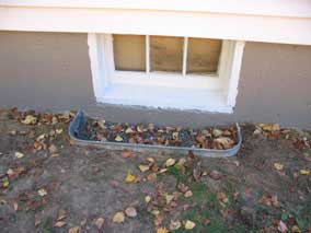 Existing metal window well at basement window