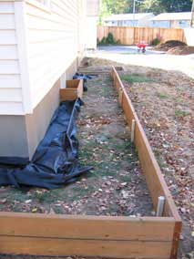 Planting bed with outside wall and landscape fabric