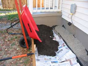 Dumping soil into planting bed