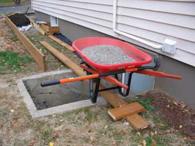 Wheelbarrow on 2x6 bridge across egress well