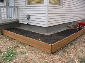 Planting bed filled back to window well