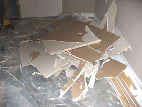 Drywall debris from west wall