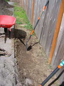 Clearing top layer of weeds, clay, gravel, and plastic