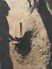 Metal fence post buried in ground