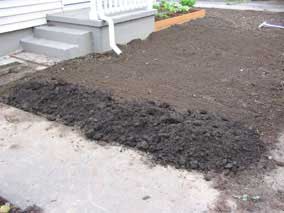 Topsoil dumped on front yard, waiting to grade