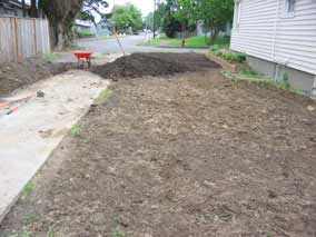 Side yard and topsoil pile just before rainfall