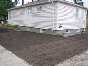 Side yard with more topsoil rolled