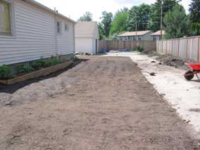 Side yard after remaining pile graded down and rolled