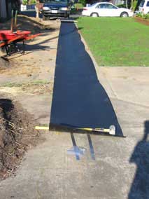 HDPE bamboo barrier unrolled on driveway