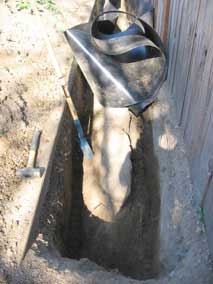 Barrier trench and trenching shovel