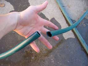 Garden hose cut in two for splicing with repair coupling