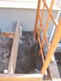 Digging out area for planting vines for north trellis