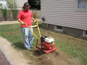 Nate helps till the west lawn