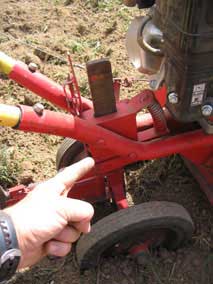 Nate points out how to adjust the tiller so the tines dig deeper