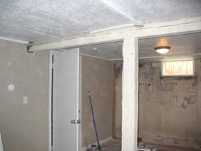 Center beam and post with drywall and pine paneling removed