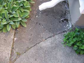 Breaking up sidewalk behind house to dig electrical trench