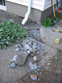 Breaking up sidewalk behind house to dig electrical trench