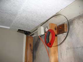 Fish tape running through basement ceiling