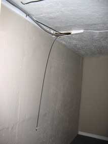 Fish tape running through basement ceiling