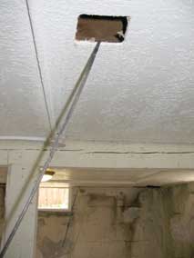 Fish tape running through basement ceiling