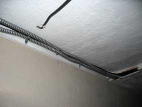 New bath heater/vent line in conduit clamped in place under line for garage circuit