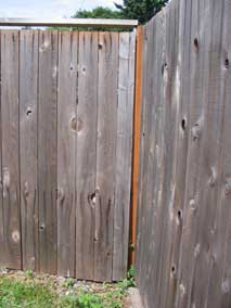 Loose section of fence in back corner