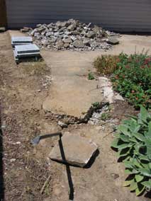 Breaking up sidewalk behind house