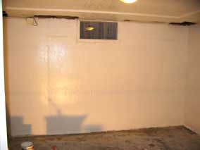 South wall of back basement room with one coat of primer