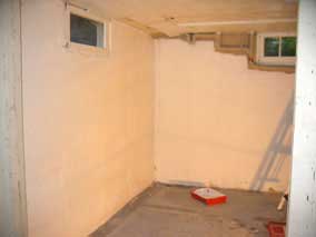 West and north walls of back basement room with one coat of primer