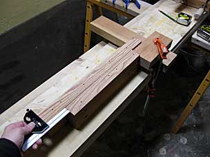 Checking stop block jig to center stretcher board on tenon board for glueing