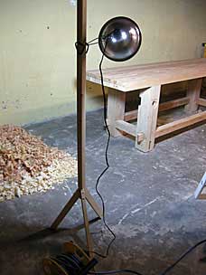 Wooden stand for clamp work light to provide raking light