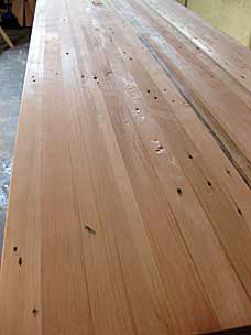 Raking light highlights tear out and other imperfections in workbench top