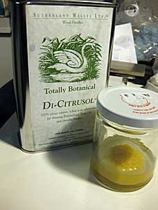 Cake of beeswax soaking in Di-Citrusol solvent to soften into a paste for finishing