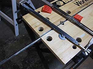 Using hacksaw to cut off a section of steel bar for parallel guide pin