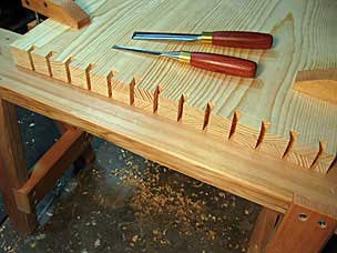 Chopping dovetail waste on tool chest panel