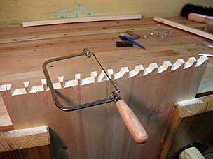 Sawing dovetail waste with coping saw