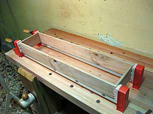 Bottom tool chest tray sides glued together and clamped to dry