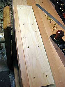 Countersinks and holes for brass screws in tool chest tray side runner