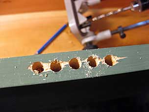 Holes drilled to begin lock mortise