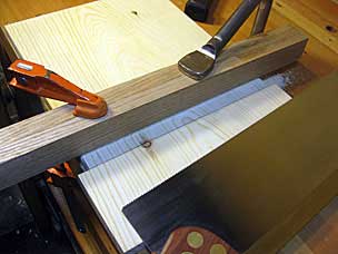 Sawing dado in end board of boarded chest