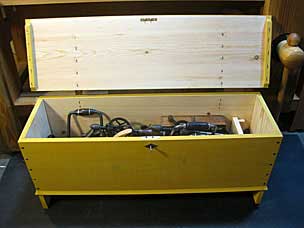 Yellow boarded chest with tools