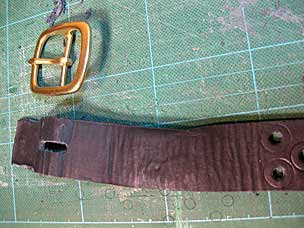 Glued leather strap opened back up to reset buckle