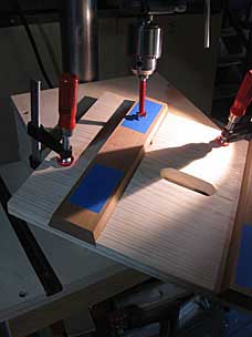 Stool set up on jig to drill angled mortise